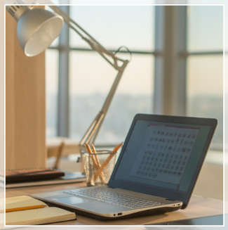 desk lamp pointing to a laptop