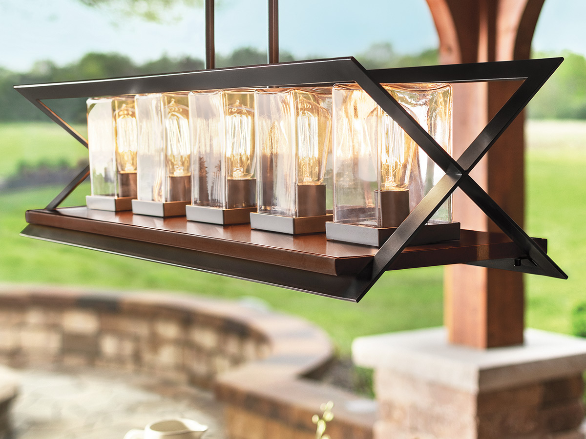 Outdoor light hanging above a table on a patio